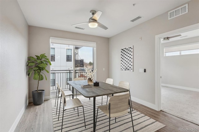 dining area with plenty of natural light, wood finished floors, and visible vents