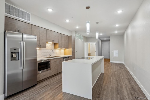 kitchen featuring appliances with stainless steel finishes, modern cabinets, a sink, and visible vents