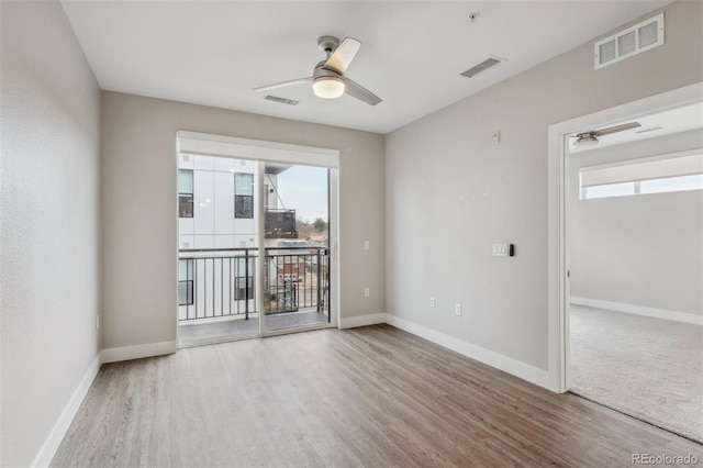 3500 S Corona St Unit 409, Englewood, CO 80113 - spare room featuring ceiling fan, baseboards, visible vents, and wood finished floors