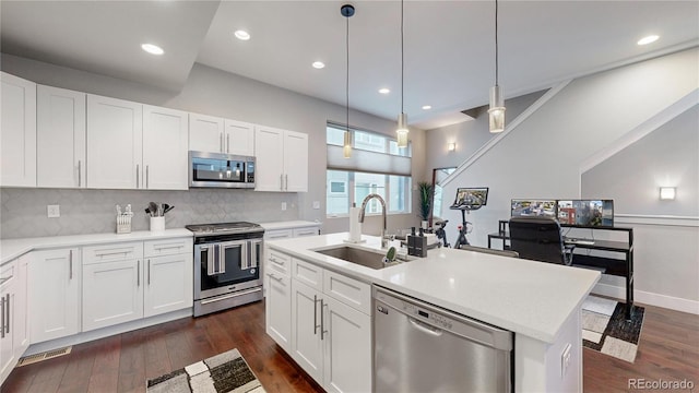 kitchen featuring white cabinetry, a center island with sink, appliances with stainless steel finishes, and sink