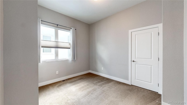 empty room featuring light colored carpet