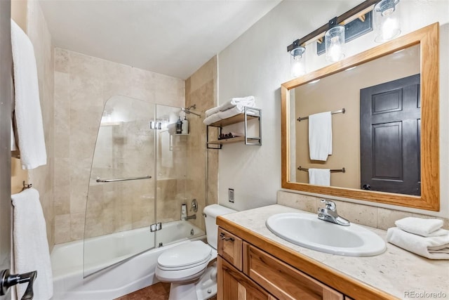 bathroom with combined bath / shower with glass door, vanity, and toilet