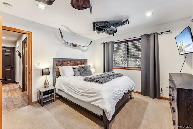 bedroom with recessed lighting, baseboards, and light colored carpet