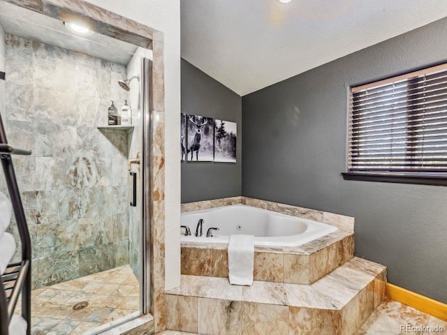 full bath featuring vaulted ceiling, a shower stall, a bath, and baseboards