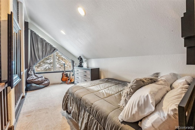 carpeted bedroom with lofted ceiling and a textured ceiling