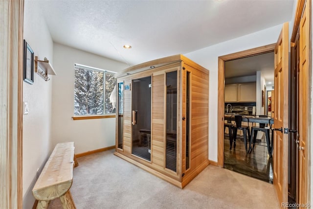 bathroom with a sauna, baseboards, and a textured ceiling