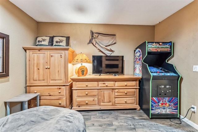 bedroom featuring baseboards and wood finished floors