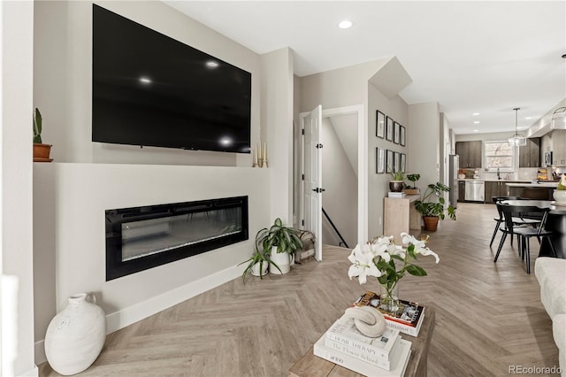 living room with light parquet flooring and sink