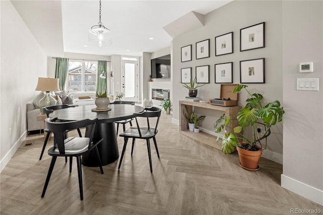 dining area featuring light parquet floors