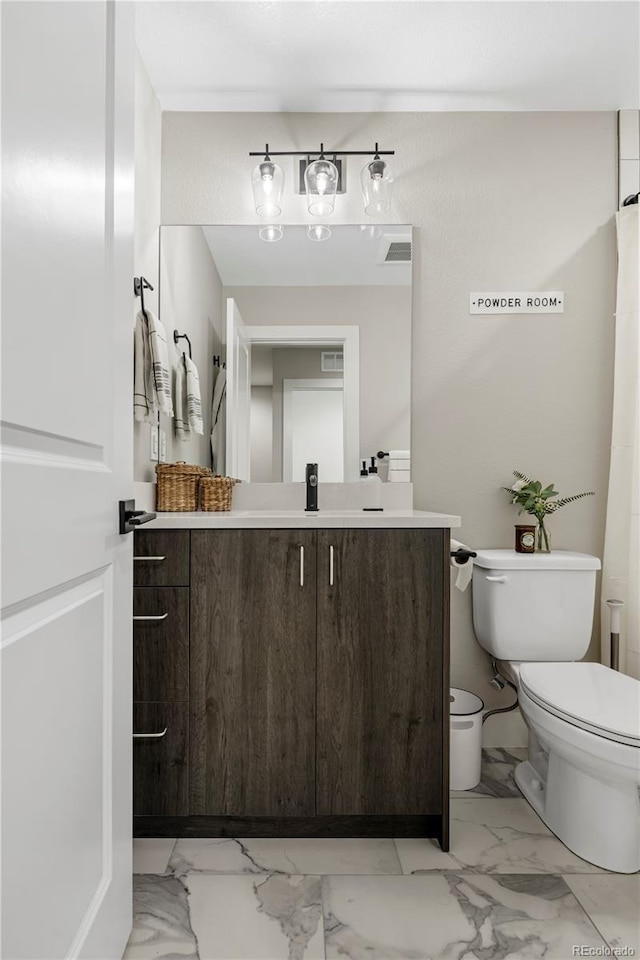 bathroom with vanity and toilet