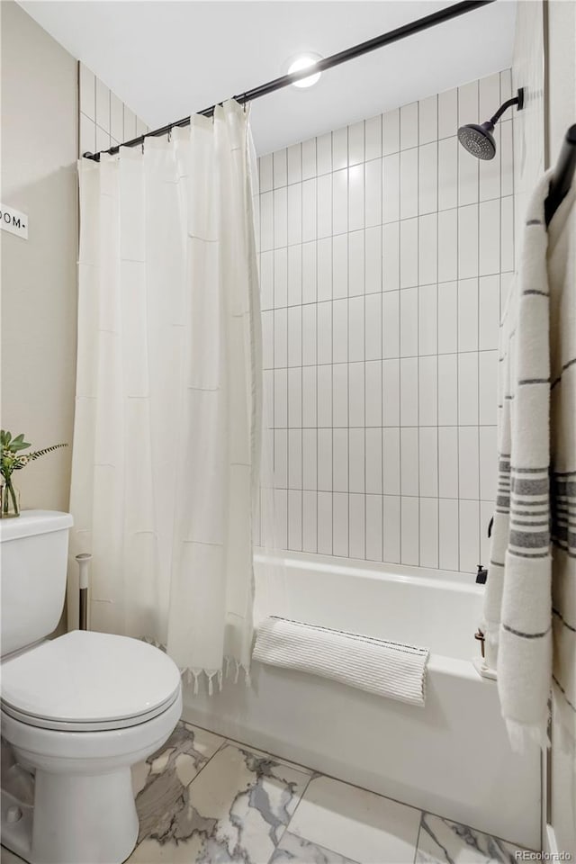 bathroom with shower / tub combo and toilet