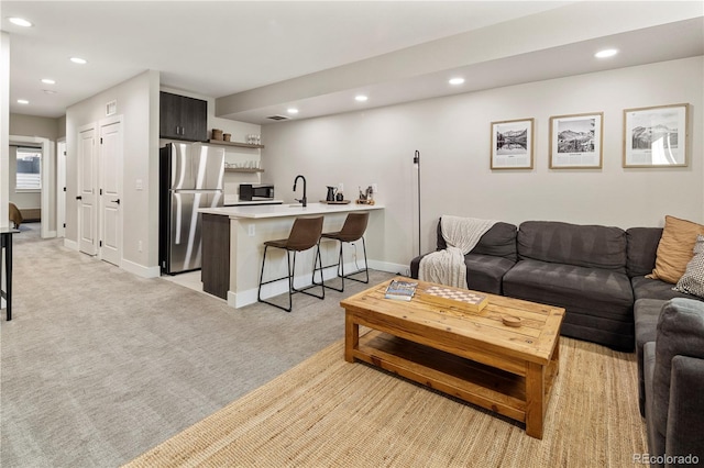 carpeted living room with indoor bar