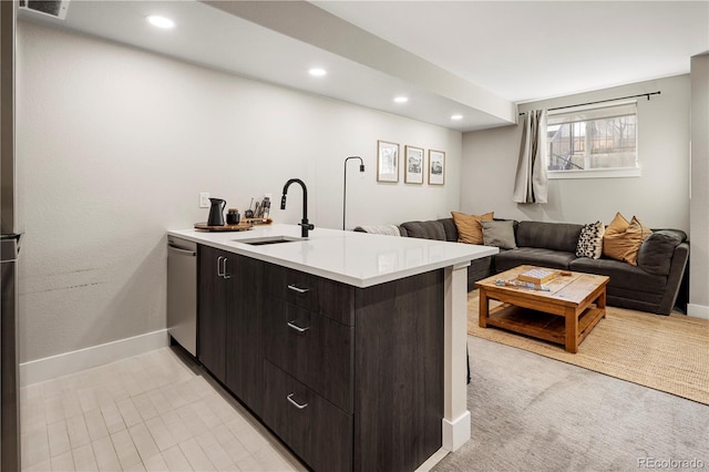 kitchen with sink, dark brown cabinets, kitchen peninsula, and dishwasher