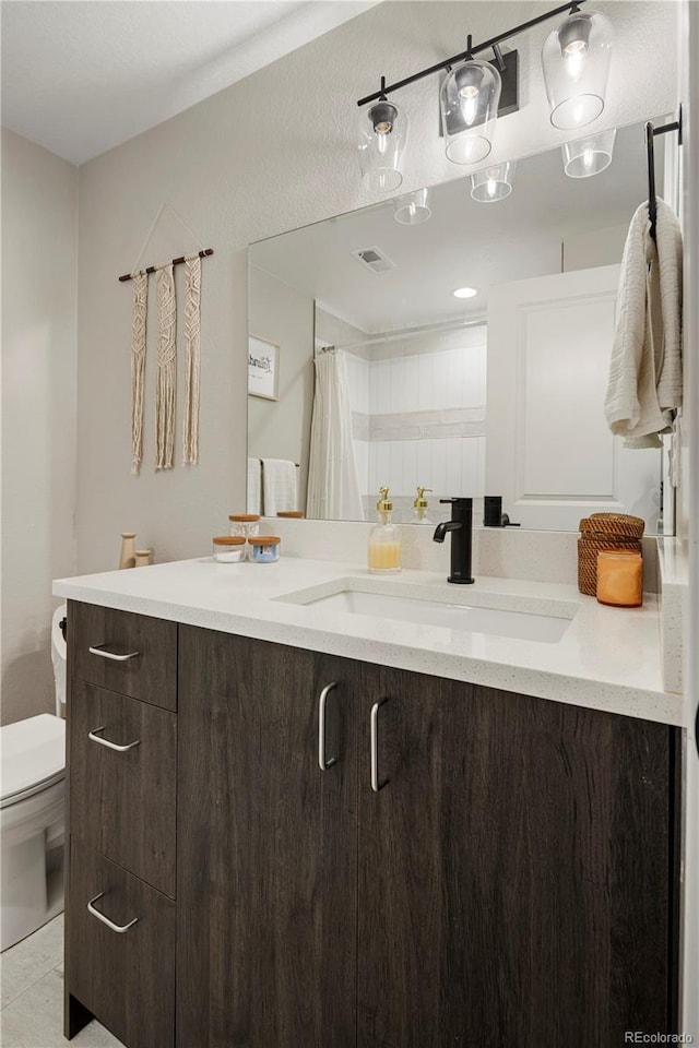 bathroom featuring vanity, toilet, and a shower with shower curtain