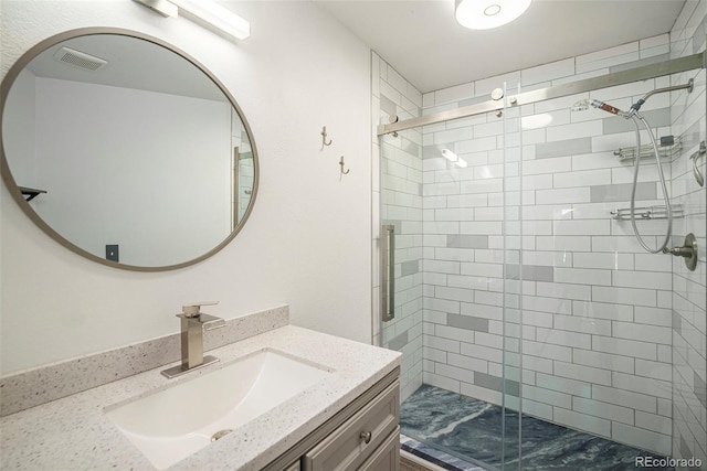 full bathroom with visible vents, a stall shower, and vanity