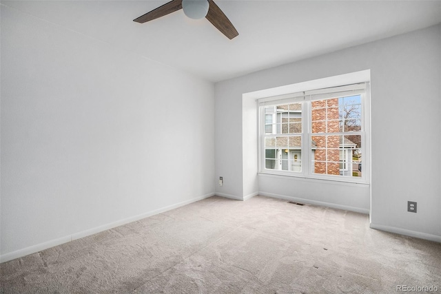 unfurnished room featuring visible vents, ceiling fan, carpet floors, and baseboards
