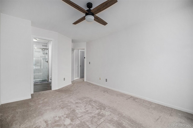 unfurnished bedroom with carpet flooring, baseboards, a ceiling fan, and ensuite bath