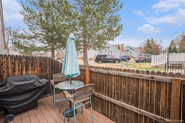wooden terrace featuring a residential view and area for grilling