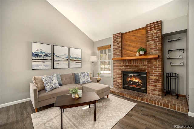 living room with high vaulted ceiling, a fireplace, baseboards, and wood finished floors
