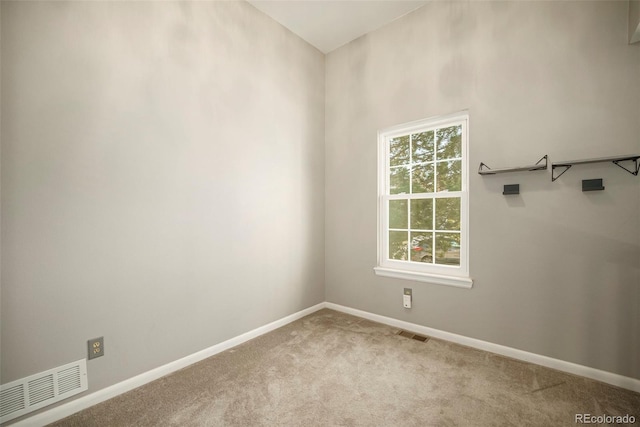 carpeted empty room featuring visible vents and baseboards