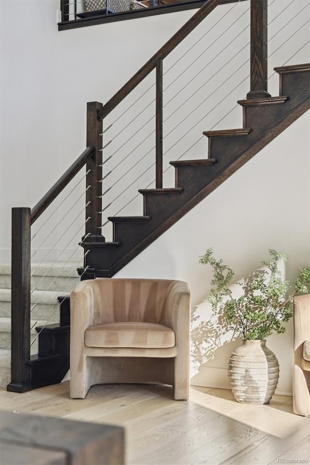 staircase with hardwood / wood-style floors