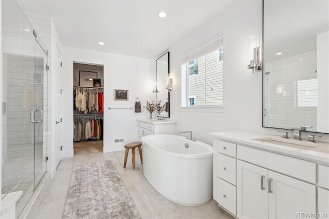 bathroom featuring vanity and separate shower and tub