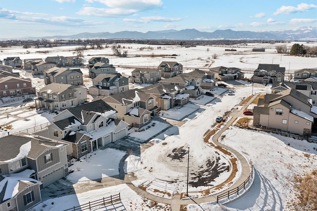 snowy aerial view with a mountain view