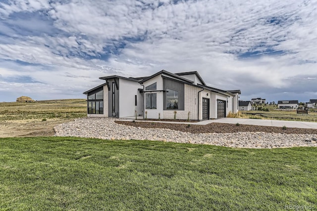 8648 Carneros Ct, Parker, CO 80138 - view of property exterior featuring a garage, driveway, a yard, stucco siding, and brick siding