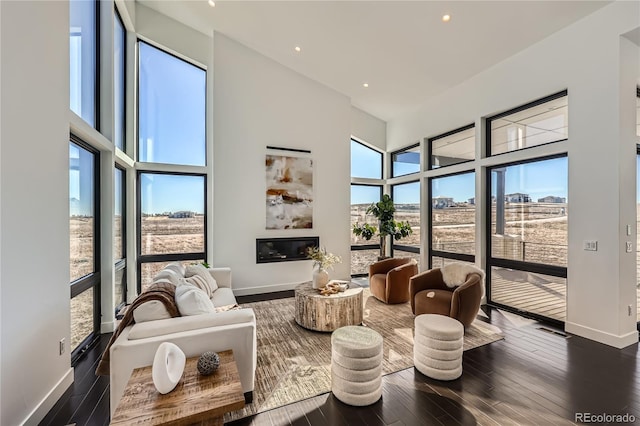 8648 Carneros Ct, Parker, CO 80138 - living area with a towering ceiling, wood finished floors, and recessed lighting