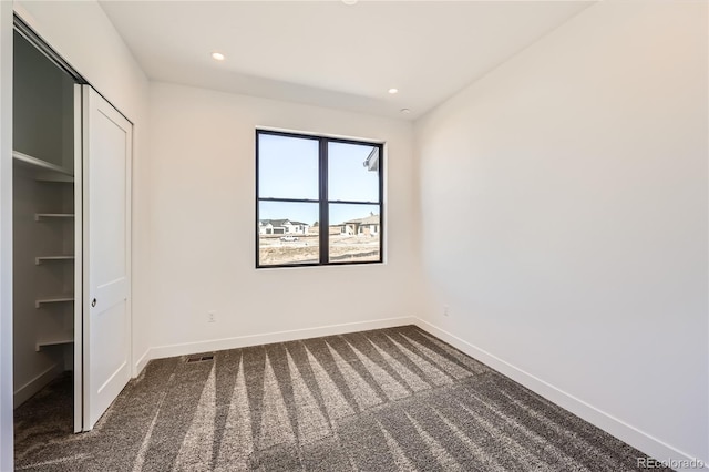 8648 Carneros Ct, Parker, CO 80138 - unfurnished bedroom featuring dark colored carpet, recessed lighting, and a closet