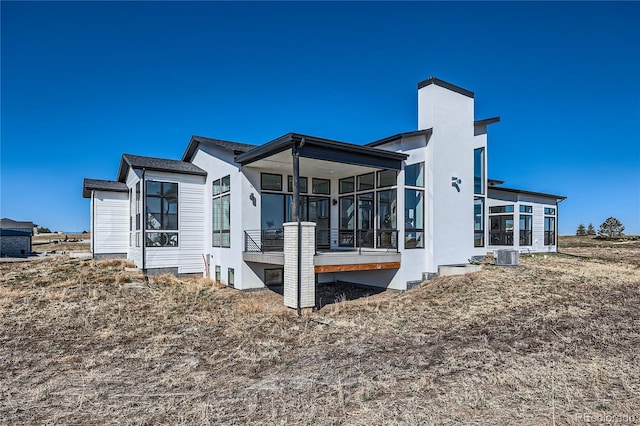 8648 Carneros Ct, Parker, CO 80138 - rear view of house featuring a sunroom and a chimney