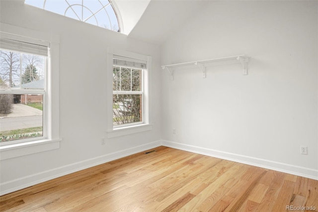 841 Niagara St, Denver, CO 80220 - spare room with baseboards, lofted ceiling, wood finished floors, and a wealth of natural light