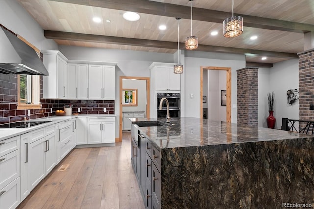25350 Ridge Way, Golden, CO 80401 - kitchen featuring wall chimney exhaust hood, black appliances, a sink, decorative backsplash, and white cabinets