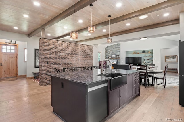 25350 Ridge Way, Golden, CO 80401 - kitchen featuring a sink, light wood-style flooring, dark stone countertops, a kitchen island with sink, and recessed lighting