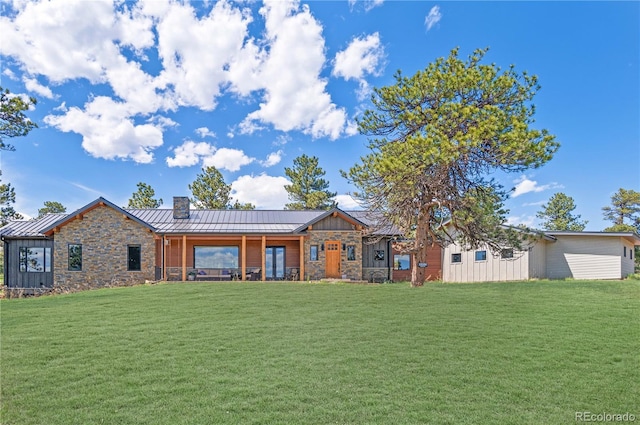 25350 Ridge Way, Golden, CO 80401 - view of front of house featuring a standing seam roof, stone siding, a front lawn, and a chimney