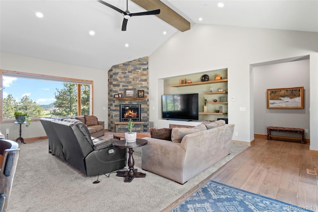 25350 Ridge Way, Golden, CO 80401 - living room with ceiling fan, beam ceiling, wood finished floors, recessed lighting, and a stone fireplace