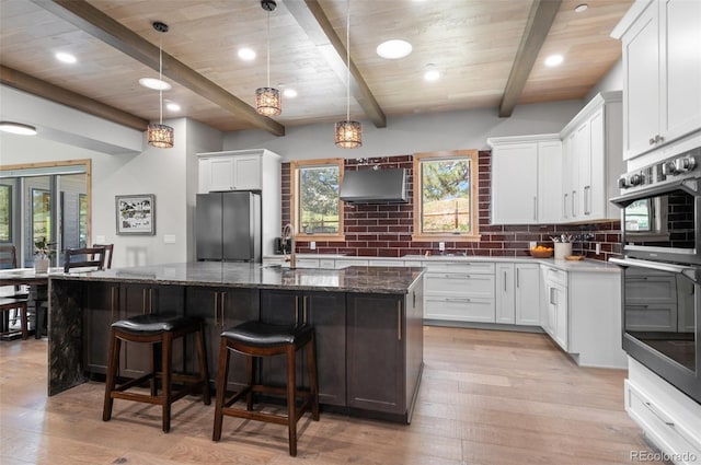 25350 Ridge Way, Golden, CO 80401 - kitchen featuring stainless steel appliances, exhaust hood, backsplash, healthy amount of natural light, and a wood ceiling with exposed beams