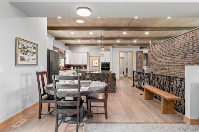 25350 Ridge Way, Golden, CO 80401 - dining area with light wood-style flooring, a wood ceiling with exposed beams, brick wall, and recessed lighting