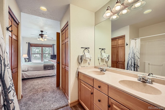 22714 US Highway 6 Unit 5945, Keystone, CO 80435 - ensuite bathroom with double vanity, a ceiling fan, and curtained shower