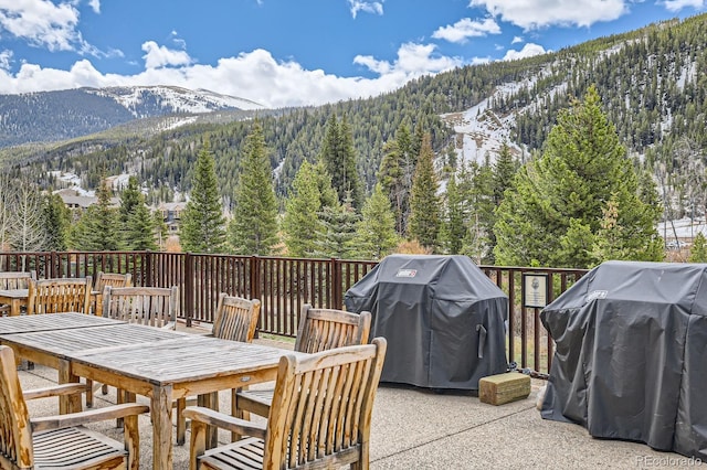 22714 US Highway 6 Unit 5945, Keystone, CO 80435 - view of patio / terrace with a mountain view, a view of trees, outdoor dining space, and grilling area