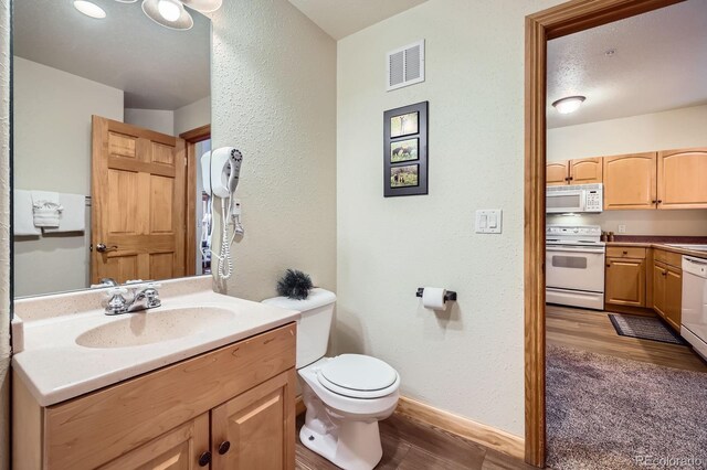 22714 US Highway 6 Unit 5945, Keystone, CO 80435 - bathroom with wood finished floors, a textured wall, and vanity