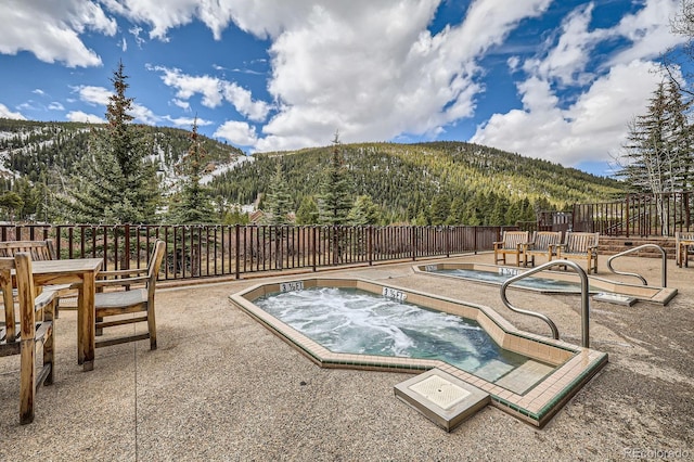 22714 US Highway 6 Unit 5945, Keystone, CO 80435 - view of pool featuring a mountain view, a patio, an in-ground hot tub, and a wooded view