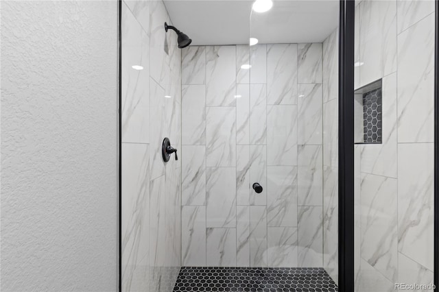 bathroom with a tile shower