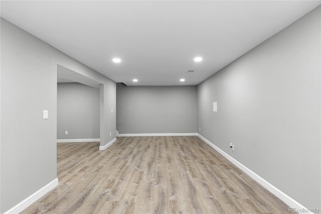 basement with light hardwood / wood-style flooring