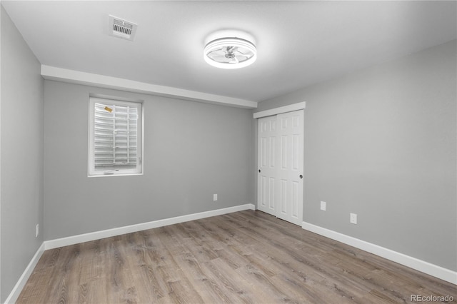 spare room featuring light wood-type flooring