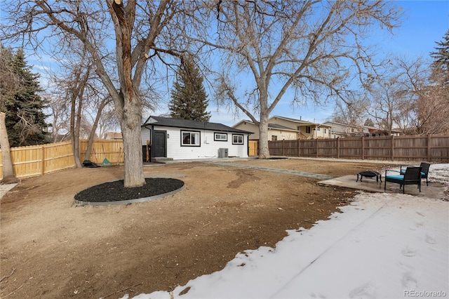 back of property with an outdoor structure, a patio area, and central air condition unit