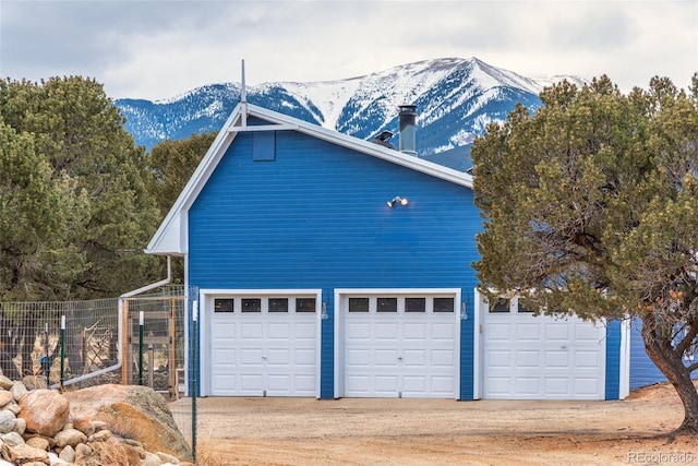 view of property exterior featuring a mountain view and an outbuilding