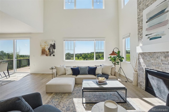 2515 Clayton Cir, Superior, CO 80027 - living area with a towering ceiling, light wood finished floors, and a fireplace