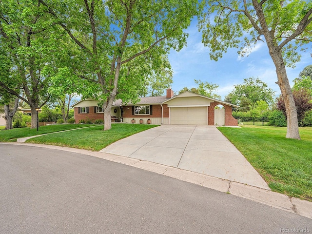 595 W Lake Ave, Littleton, CO 80120 - ranch-style house featuring brick siding, a garage, driveway, a chimney, and a front yard