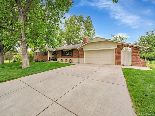 595 W Lake Ave, Littleton, CO 80120 - single story home featuring a garage, concrete driveway, brick siding, a front lawn, and a chimney